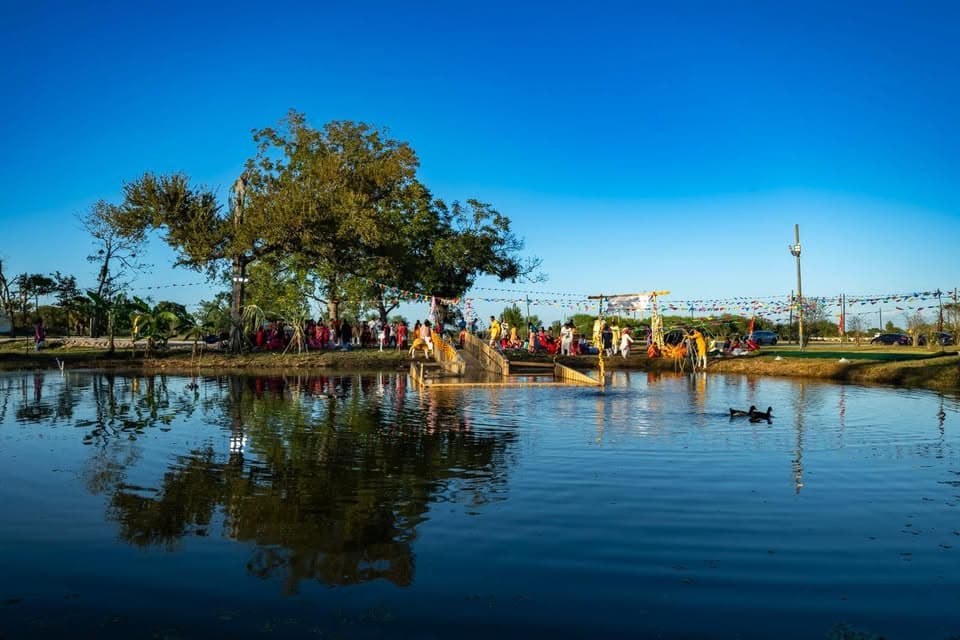 Devotees gathered at the pond ghat of Jagannath Hindu Temple of Rosenberg during Chhath Puja